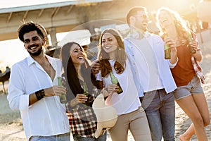 Group of happy friends partying on beach