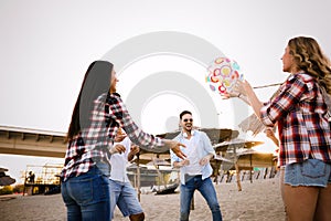 Group of happy friends partying on beach