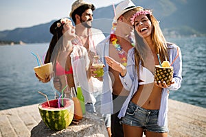 Group of happy friends partying and having fun on summer vacation