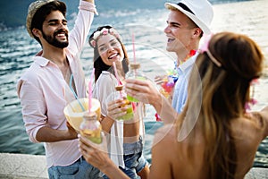 Group of happy friends partying and having fun on summer vacation