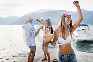 Group of happy friends partying and having fun on summer vacation