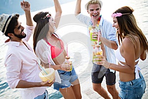 Group of happy friends partying and having fun on summer vacation