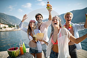 Group of happy friends partying and having fun on summer vacation