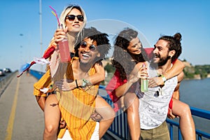 Group of happy friends people having fun together outdoors