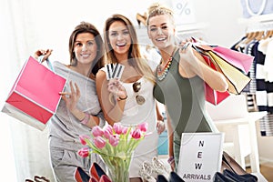 Group of happy friends shopping in store