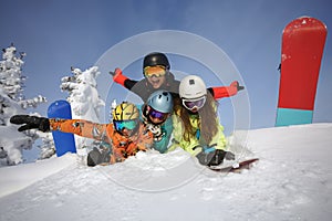 Group of happy friends snowboarders having fun