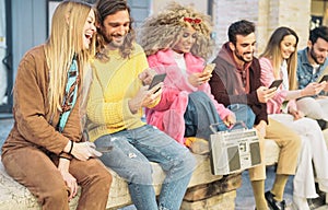 Group happy friends using mobile smartphones in the city - Millennial young people having fun with new trendy apps for social