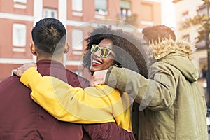 Group of happy friends walking in the street. Friendship concept