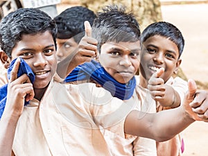 Group of happy funny children friends boys classmates smiling laughing showing thumb up gesture at the school