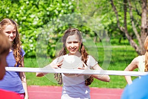 Group of happy girls playing volleyball together