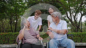Group of happy grandparents and grandchild talking and laugh together, grandparent sitting on wheelchair. Retirement lifestyle