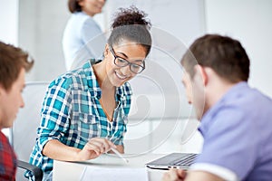 Group of happy high school students with workbook photo