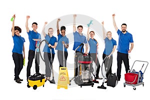 Group Of Happy Janitors With Cleaning Equipment