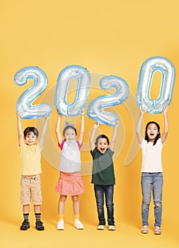 Group of happy kids celebrating and showing 2020 new year concepts