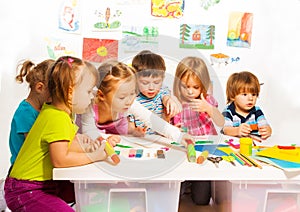 Group of happy kids painting and