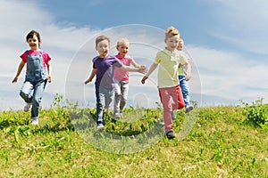 Group of happy kids running outdoors