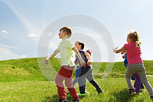 Group of happy kids running outdoors
