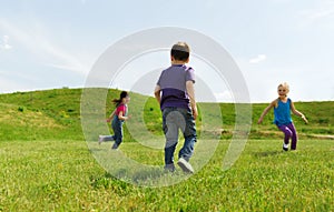 Group of happy kids running outdoors