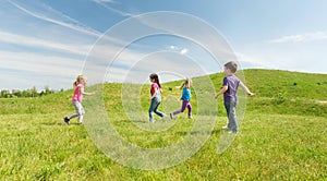 Group of happy kids running outdoors