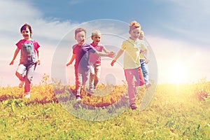 Group of happy kids running outdoors