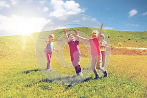 Group of happy kids running outdoors photo