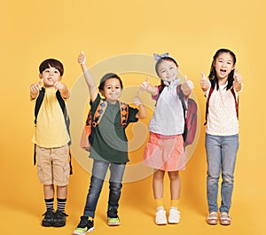 Group of happy kids showing the thumbs up