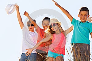 Group of happy kids together portrait over sky