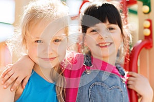 Group of happy little girls on children playground