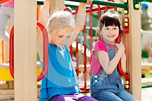 Group of happy little girls on children playground