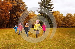 Group of happy little kids running outdoors