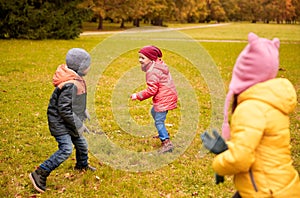 Group of happy little kids running outdoors