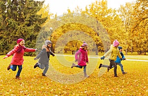 Group of happy little kids running outdoors