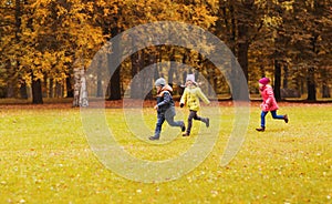 Group of happy little kids running outdoors