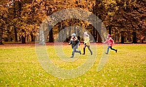 Group of happy little kids running outdoors