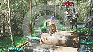 Group of happy men and women having fun at water adventure park