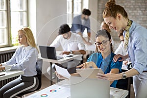 Group of happy multiethnic business people cooperating, working on meeting in corporate office