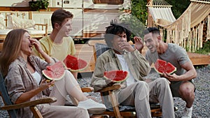 Group Of Happy Multiethnic Friends Eating Watermelon At Outdoor Party In Camping
