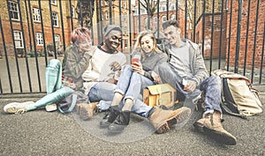 Group of happy multiracial best friends having fun using mobile phone