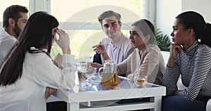 Group of happy multiracial best friends, talking, laughing at meeting