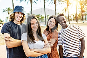 Group of happy multiracial friends posing outdoors