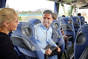 Group of happy passengers in travel bus