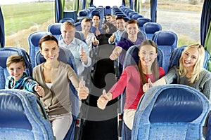 Group of happy passengers travelling by bus