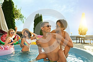 Group of happy people enjoying fun pool party