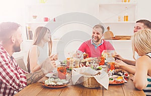 Group of happy people at festive table dinner party