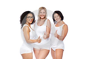 Group of happy plus size women showing thumbs up