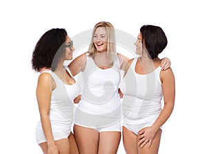 Group of happy plus size women in white underwear