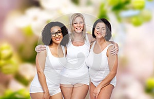 Group of happy plus size women in white underwear