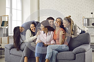 Group of happy positive young women having fun while spending free time together