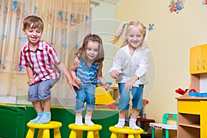 Group of happy preschool kids jumping