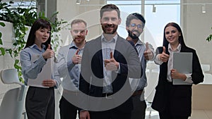 Group happy professional diverse businessmen and businesswomen smiling employees with team leader show thumbs up vote